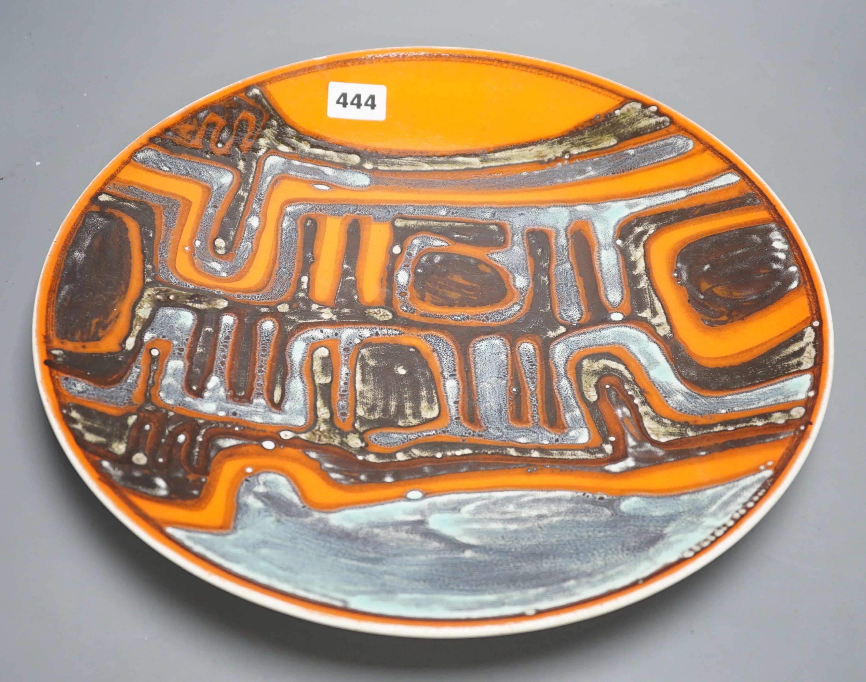 A Poole pottery orange Delphis designed charger-36 cms diameter.